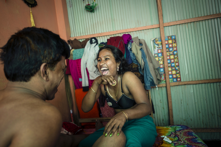 Bonna, 27, a sexworker in the Kandapara brothel in Tangail, is laughing with a condom in the hand. When she was 7 years old she was raped by her stepfather. She run away from home with 10 years as a man picked her off the street and sold her into a brothel. She has two regularly customers. On average she earn 1500 Taka (19 $) per day.